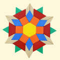 A colorful geometric star-shaped pattern made of plastic geometric pieces on a butter background.