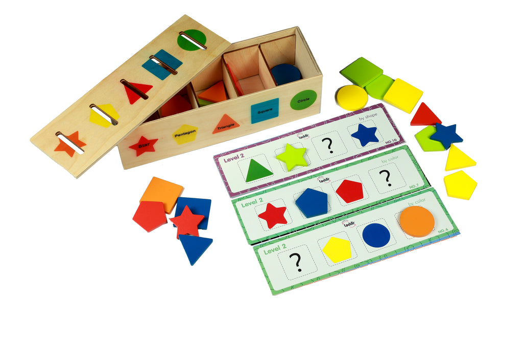 Educational toy set with shape sorting box and cards on a white background
