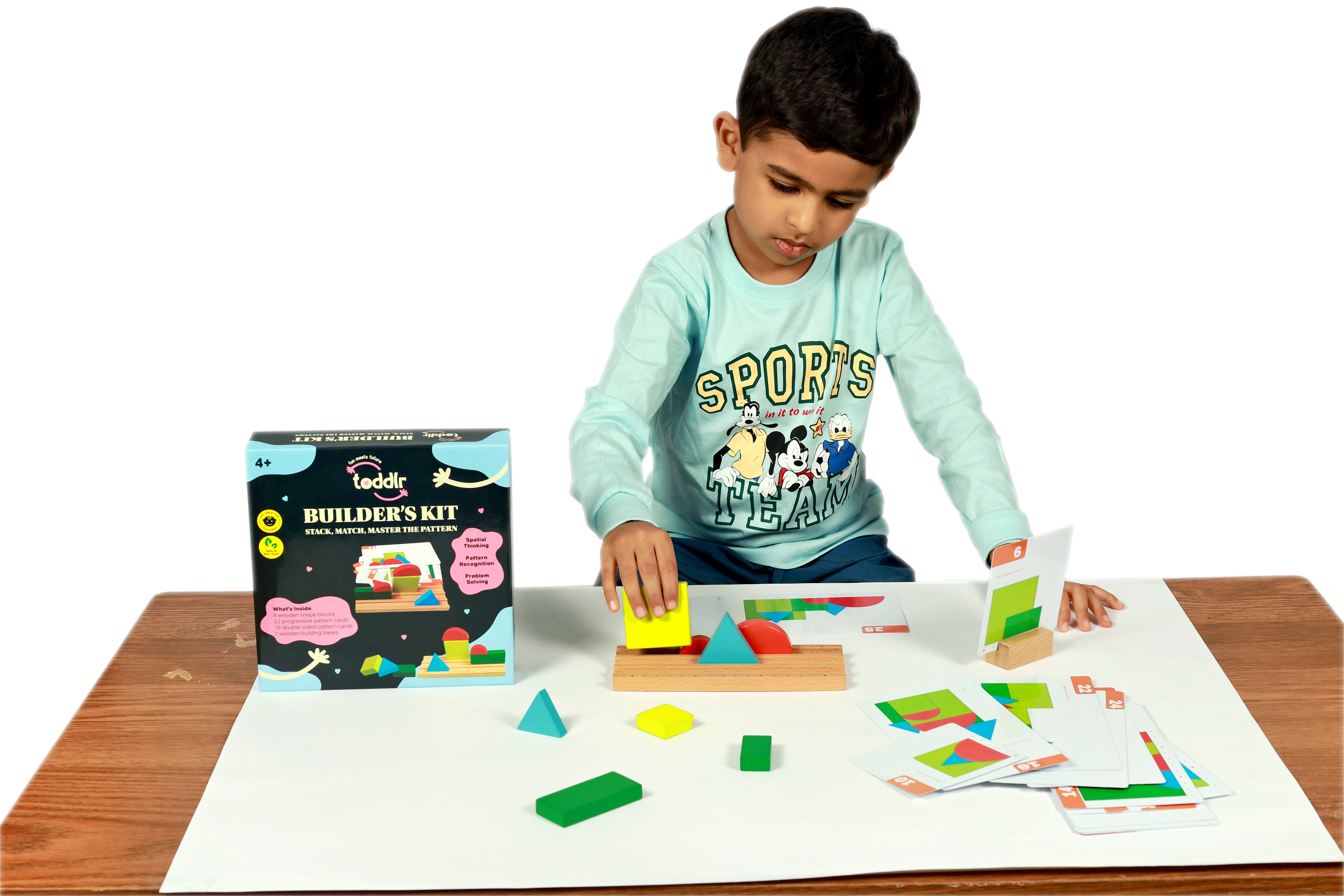 Child playing with a wooden building block set on a table
