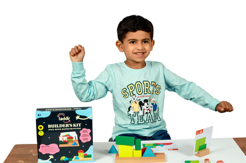 Child celebrating with toddlr's builder's kit on a white background